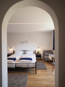 
A bed or beds in a room at Gesundheitshotel Witzigmann - das vegane Hotel in Oberstaufen
