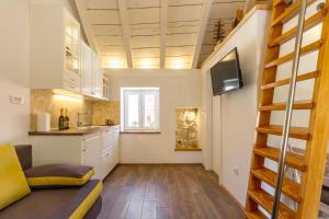 a living room with a staircase and a kitchen at Romantic Apartment in Center in Split