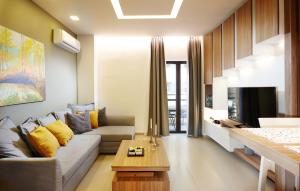 a living room with a couch and a tv at Armi Luxury Apartment in the Heart of the City in Chania Town