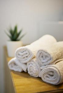 a pile of towels sitting on a table at Armi Luxury Apartment in the Heart of the City in Chania Town
