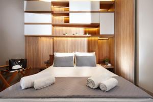 a bedroom with a bed with two towels on it at Armi Luxury Apartment in the Heart of the City in Chania Town
