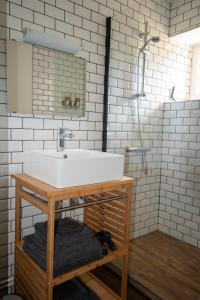 a bathroom with a white sink and a mirror at Moulin Des Comtes - Gite D'Leau in Viverols