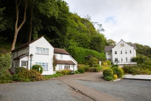a couple of white houses and a driveway at Cottage In The Wood in Great Malvern