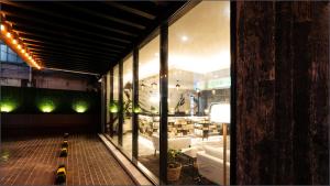 a window of a store with a bench in front of it at LALA VIANCO BUSINESS Hotel in Busan