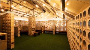 a room with a bunch of wooden boxes on the wall at LALA VIANCO BUSINESS Hotel in Busan