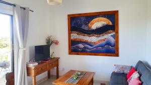 a living room with a couch and a painting on the wall at Tina’s Cozy Studio in Polis Chrysochous