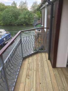 a balcony with a view of a river at Waterfront House In The Heart Of St Neots in Saint Neots