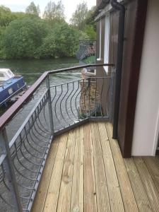 a balcony with a view of a river at Waterfront House In The Heart Of St Neots in Saint Neots