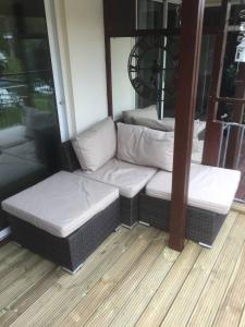 a porch with two couches sitting in a room at Waterfront House In The Heart Of St Neots in Saint Neots