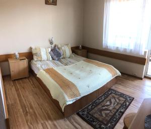 a bedroom with a large bed with a wooden floor at Pensjonat Klaudia in Ostrowo