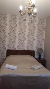 a bedroom with a bed with two towels on it at Guest House Gzirishvili in Kvareli