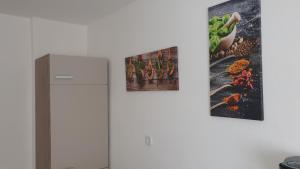 two pictures hanging on a wall next to a refrigerator at Ferienwohnung Biewer in Trier +4 photos