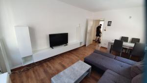 a living room with a couch and a tv at Ferienwohnung Biewer in Trier