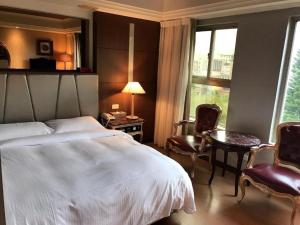 Letto o letti in una camera di JBG Hotspring Resort Hotel