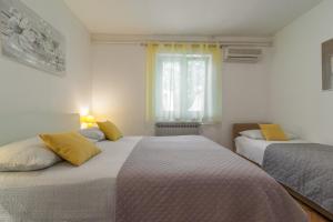 Postel nebo postele na pokoji v ubytování Apartments Tolic