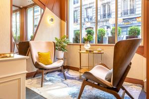 two chairs in a room with a window at Hôtel Veryste & Spa Paris in Paris