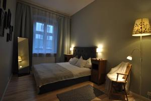 Poznańska Apartment tesisinde bir odada yatak veya yataklar
