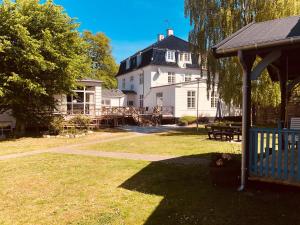 una gran casa blanca con cenador en un patio en Rørvig Centret, en Rørvig