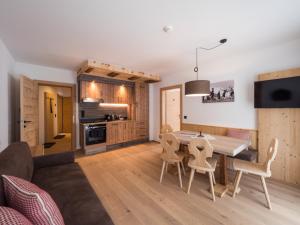 a kitchen and living room with a table and chairs at Almhittn - Luxus Appartements in Finkenberg