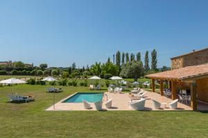 a swimming pool with lounge chairs and a house at Es Portal Restaurant i Hotel Boutique - Adults only in Pals