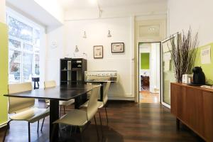 a kitchen with a table and chairs in a room at Lisbon Garden Flower in Lisbon