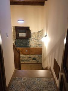 a room with a stone wall and a stairway at La Casa Vieja de Caneo - APARTAMENTOS RURALES 3 llaves in Luarca