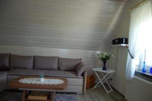a living room with a couch and a table at Ferienwohnung Hertha in Wernigerode