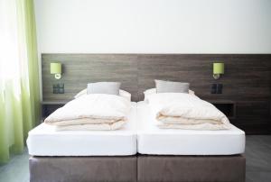 Voodi või voodid majutusasutuse eee Hotel Liezen toas