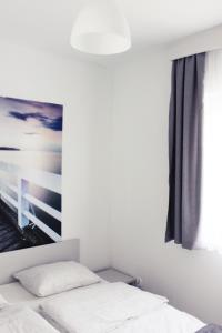 Postel nebo postele na pokoji v ubytování Nowe Apartamenty Puck