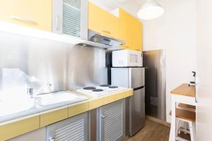 a kitchen with a sink and a refrigerator at Résidence Le Suquet in Cannes