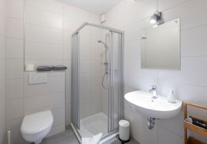 a bathroom with a shower and a toilet and a sink at Apartment Liß in Gladbeck