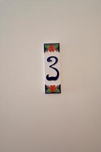 a sign with the number three on a wall at Al Duomo guest house in Como