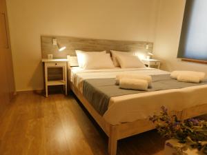 a bedroom with a large bed with a wooden headboard at Villa Anastasia in Kalamaki