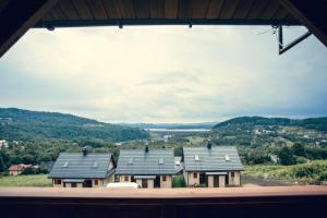a view of some houses from a window at Osada Bóbrka nad Soliną in Solina