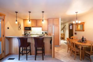 a kitchen with a wooden table and a dining room at North Star - Ski View Condo in Truckee