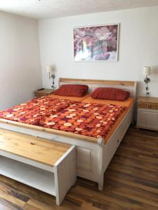a bedroom with a large bed with a checkerboard mattress at Gästehaus Glock in Marbach am Neckar