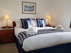 a bedroom with a large bed with towels on it at Crail House Apartments in Crail