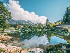 a view of a lake with mountains in the background at Übergossene Alm Resort in Dienten am Hochkönig