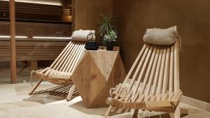 two wooden chairs sitting next to each other in a room at Chalet l'Ardoisière in Villard-Reculas