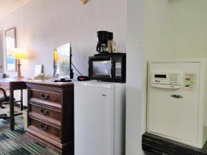 a room with a refrigerator and a microwave on top of it at Sprucewood Inn in Elyria