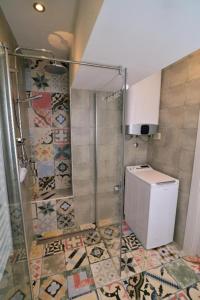 een douche met een glazen deur in de badkamer bij Apartments Knezgrad in Lovran