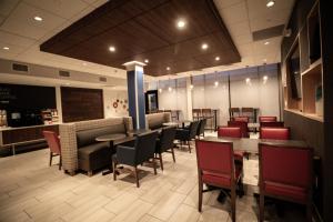 a dining room with tables and chairs in a restaurant at Holiday Inn Express & Suites - Boston South - Randolph by IHG in Randolph