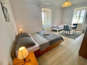 a bedroom with a bed and a desk and a table at Anka in Nerezine