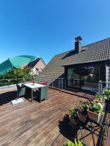 una terrazza con tavolo e sedie su una casa di Ferienwohnung GOMO a Stockelsdorf