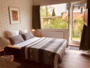 a bedroom with a bed and a large window at Rørvig Centret in Rørvig +79 photos
