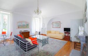 a living room with a couch and a table at Bel Faggio Rosso apartment in Menaggio