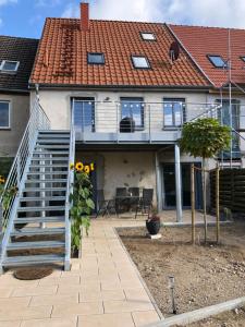 a house with a staircase and a roof at Ferienwohnung Zur Auszeit Kontorhaus Malchow in Malchow