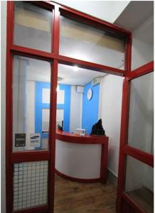 a room with a red door and a counter in a building at Yusun Guesthouse in Busan