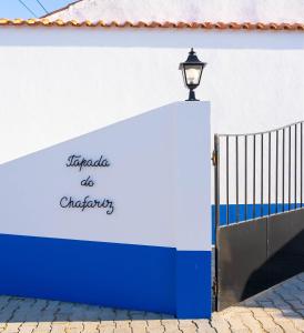 a blue and white wall with a light on it at Tapada do Chafariz in Estremoz