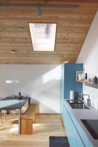 a kitchen with wooden ceilings and a skylight at Ferienhaus Z‘ Gädi in Ernen
